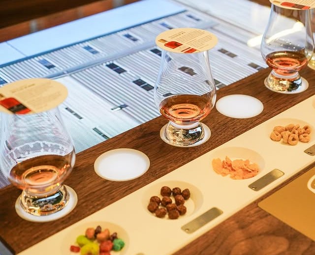 Bourbon tasting flight with cereal pairings at Bardstown Bourbon Company tasting bar.